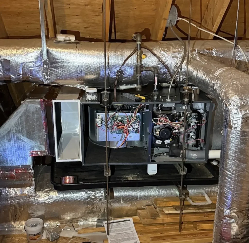 Horizontal attic air handler opened to expose blower and control components