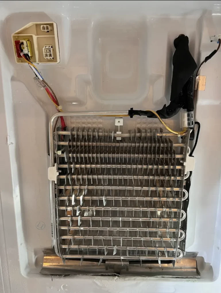Exposed evaporator coil and fan compartment inside commercial refrigeration equipment