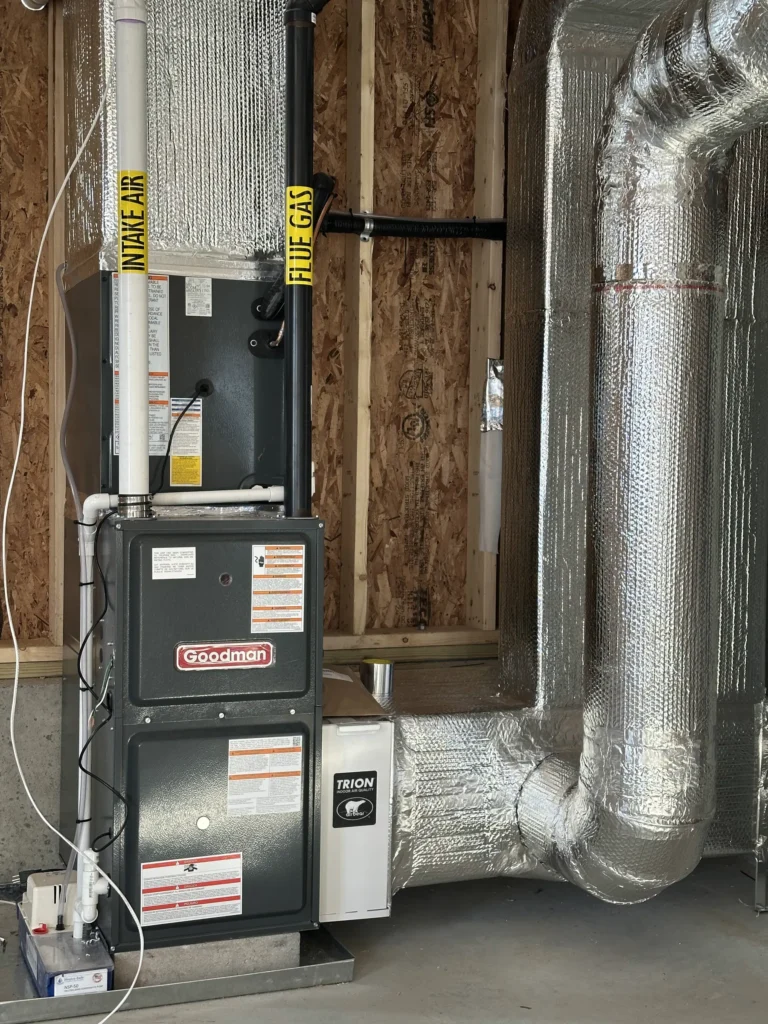 Compact basement furnace installation with organized venting and duct connections
