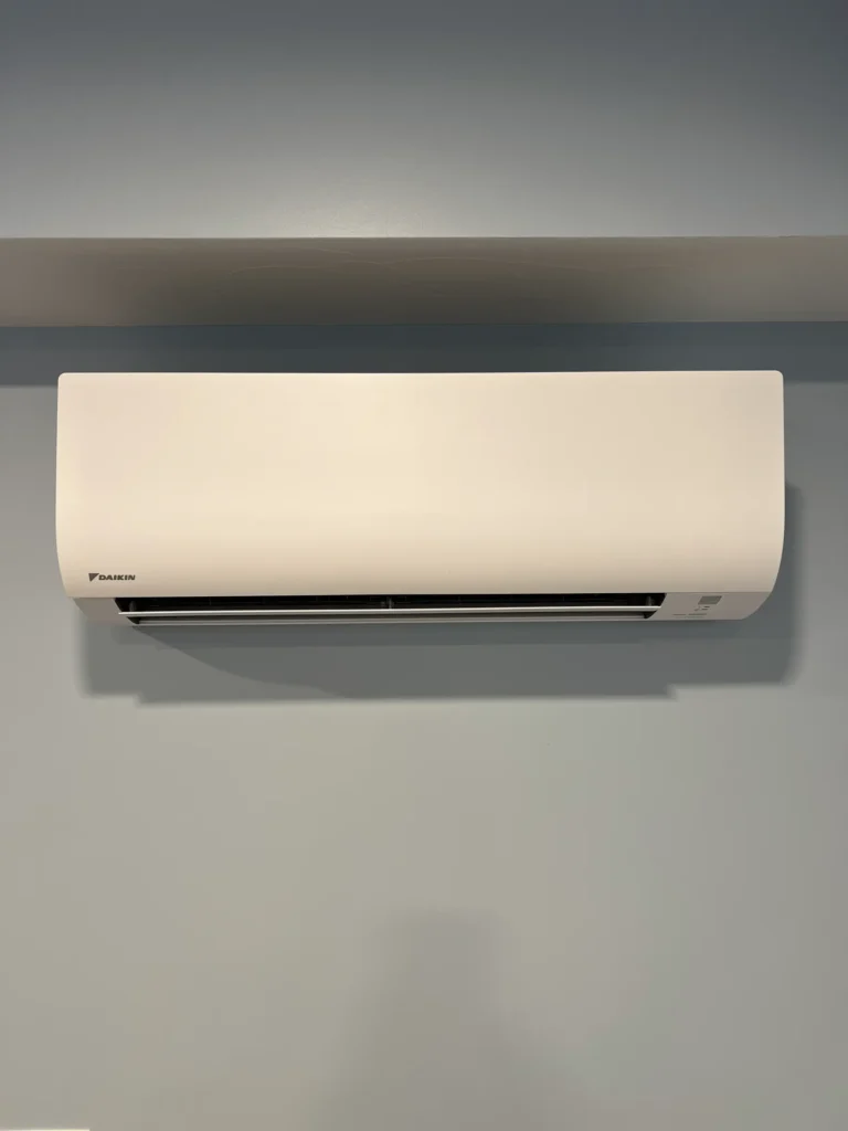 White Daikin ductless mini-split indoor unit installed high on a finished wall