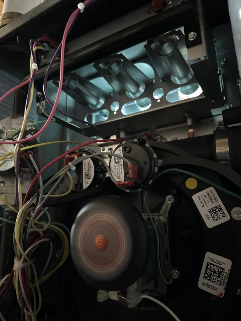 Operating furnace blower assembly exposed during heating-system repair