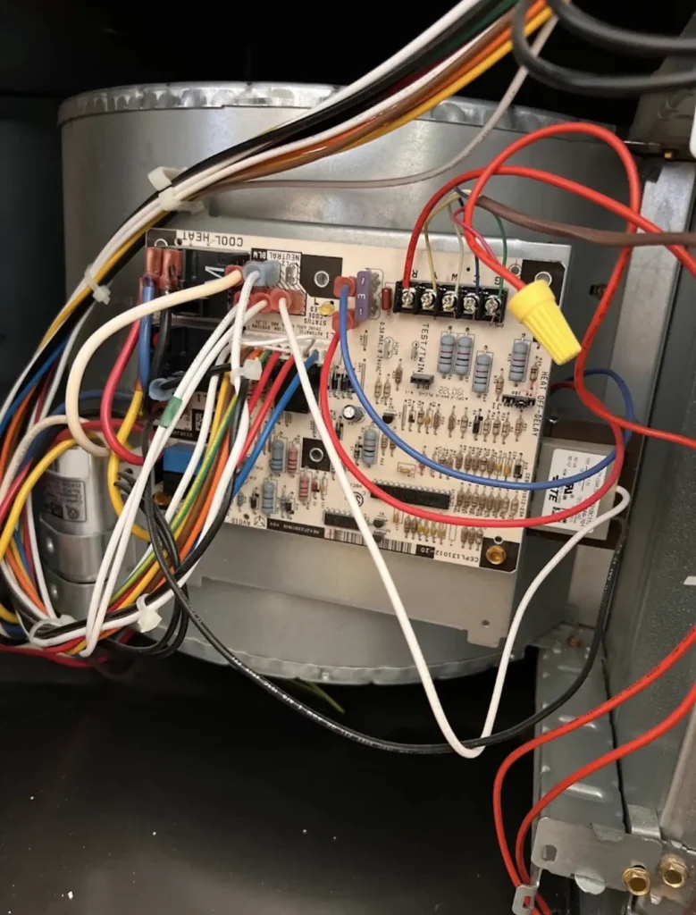 Furnace control board with labeled low-voltage and line-voltage wiring