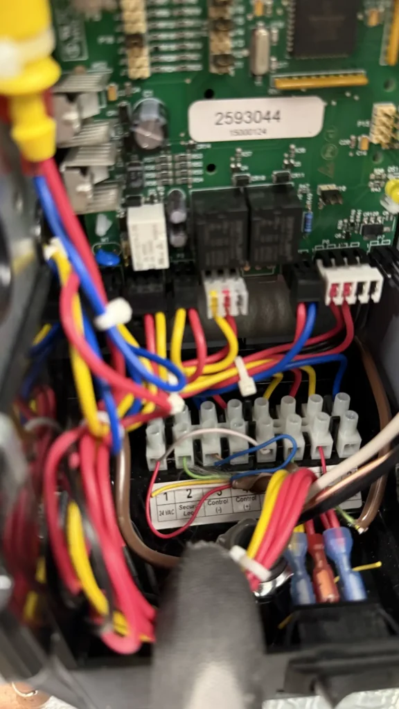 Close-up of furnace control board wiring during electrical diagnostics