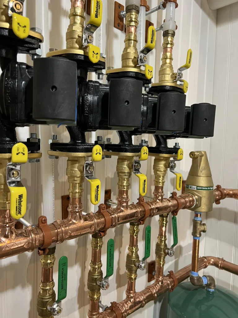 Copper hydronic heating manifold with multiple zone circulators and shutoff valves