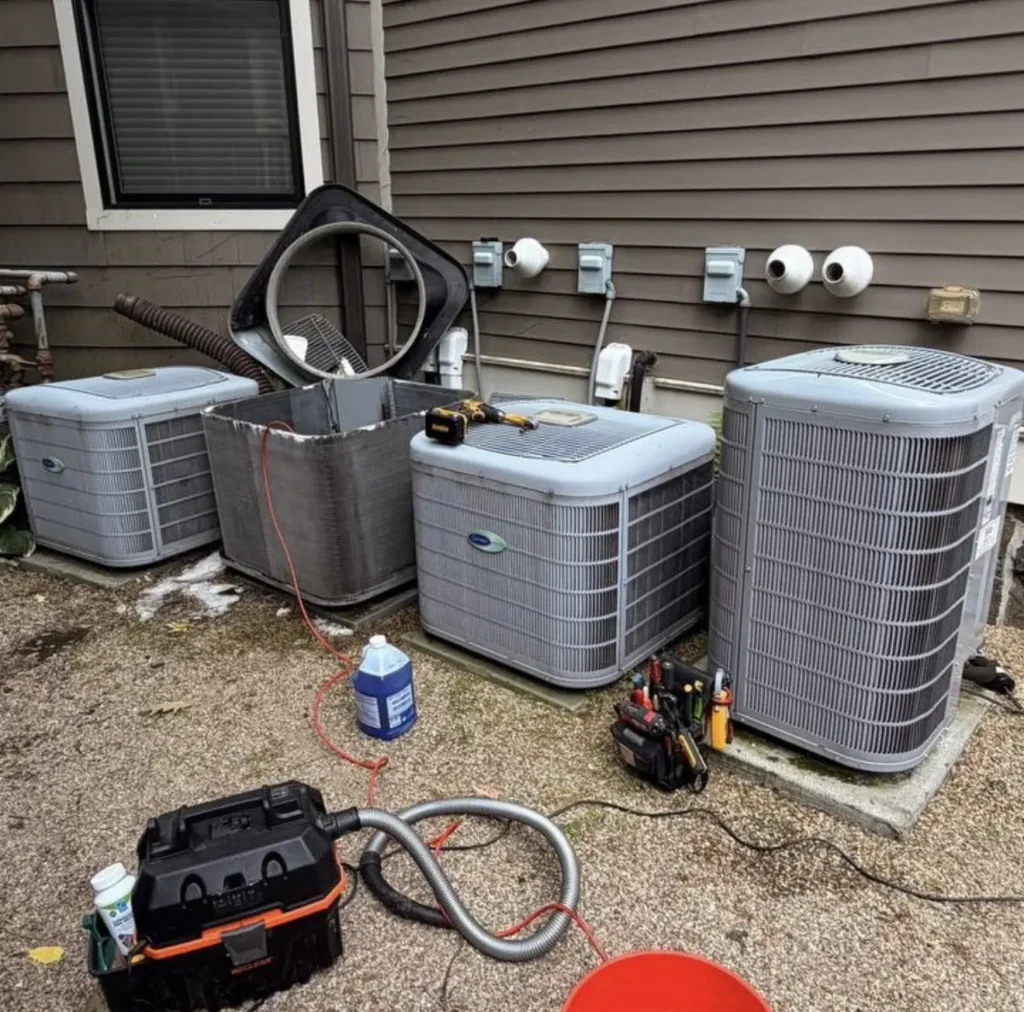 Three outdoor AC condensers with service tools and refrigerant equipment