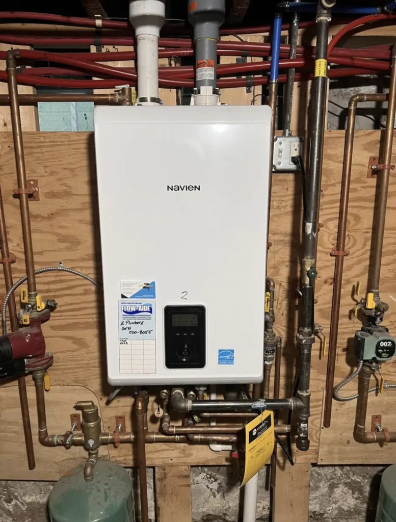 Wall-mounted Navien tankless water heater with organized copper and hydronic piping